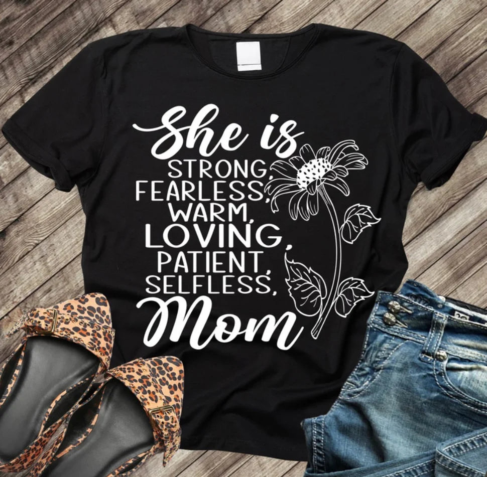 She Is Mom” Graphic Tee – A Tribute to Her Strength and Love